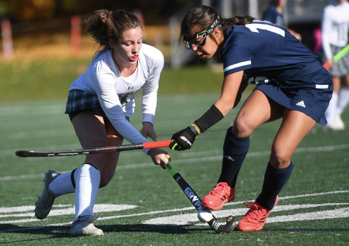 Guilford's Allie Petonito, left, is challenged for the ball by Wethersfield's Sadie Ruiz during the top ranked Grizzlies' victory in the CIAC Class M field hockey championship at Wethersfield High School in Wethersfield, Conn. on Saturday, November 20, 2021.