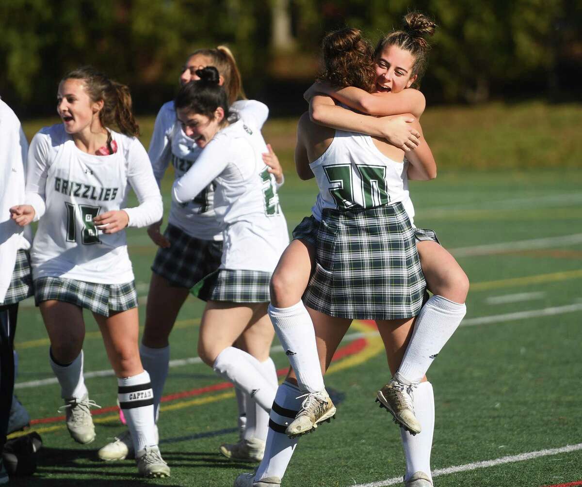 Guilford players celebrate their victory over Wethersfield in the CIAC Class M field hockey championship at Wethersfield High School in Wethersfield, Conn. on Saturday, November 20, 2021.