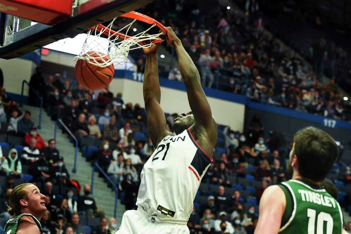 Adama Sanogo, seen dunking against Binghamton early in the season, has a 26 points and a career-high 18 rebounds in an overtime win over St. John’s Wednesday.