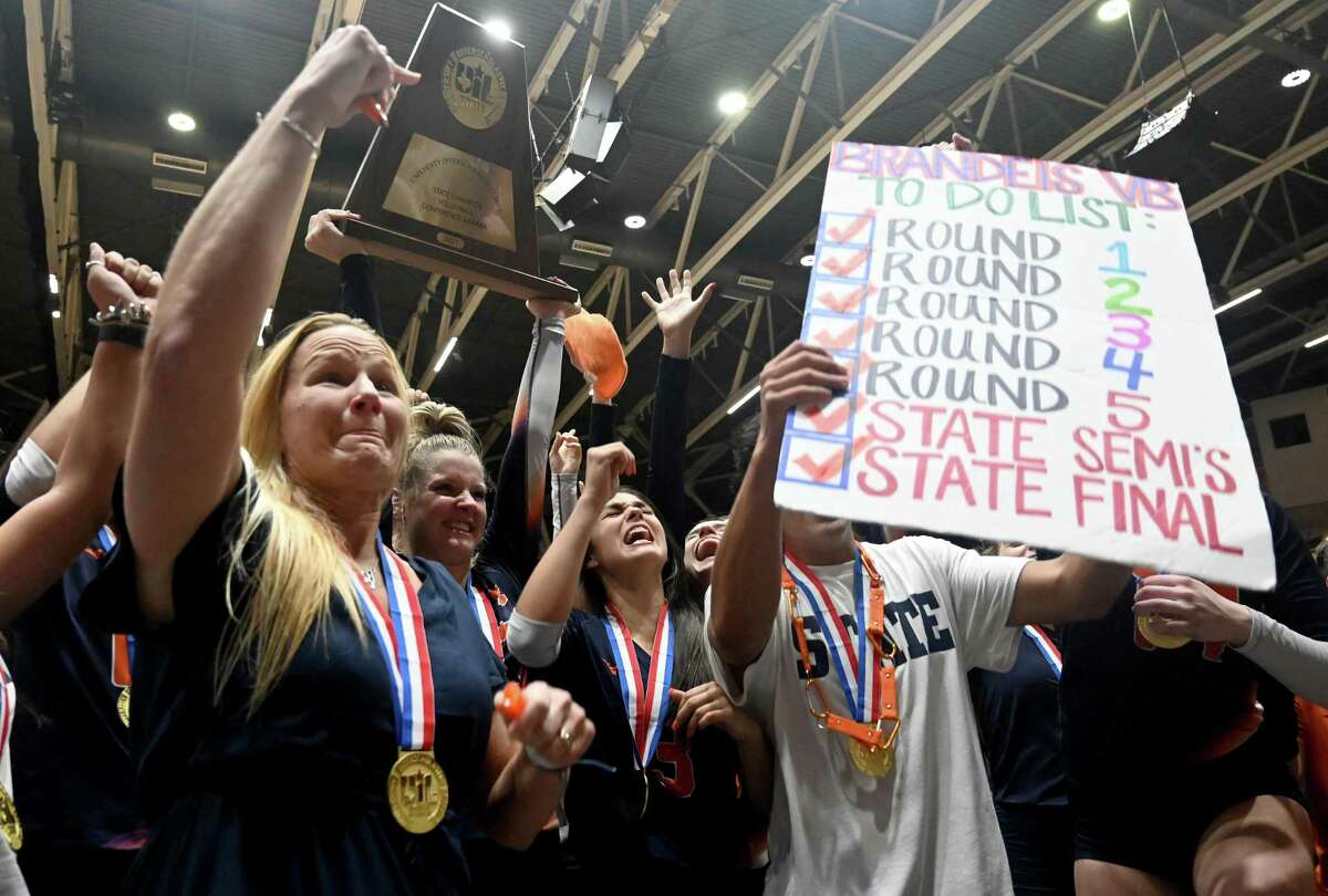 Brandeis players and coaches celebrates with students and fans after their 5 set win of the Class 6A volleyball state finals match between Brandeis and Keller, Saturday, Nov. 20, 2021, in Garland, Texas. (Matt Strasen/Special Contributor)
