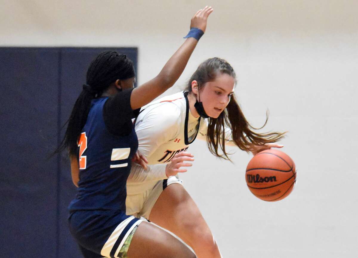 In this file photo, Edwardsville's Elle Evans looks to get past a defender against Whitney Young. Evans scored 16 points in Thursday's win over Alton.