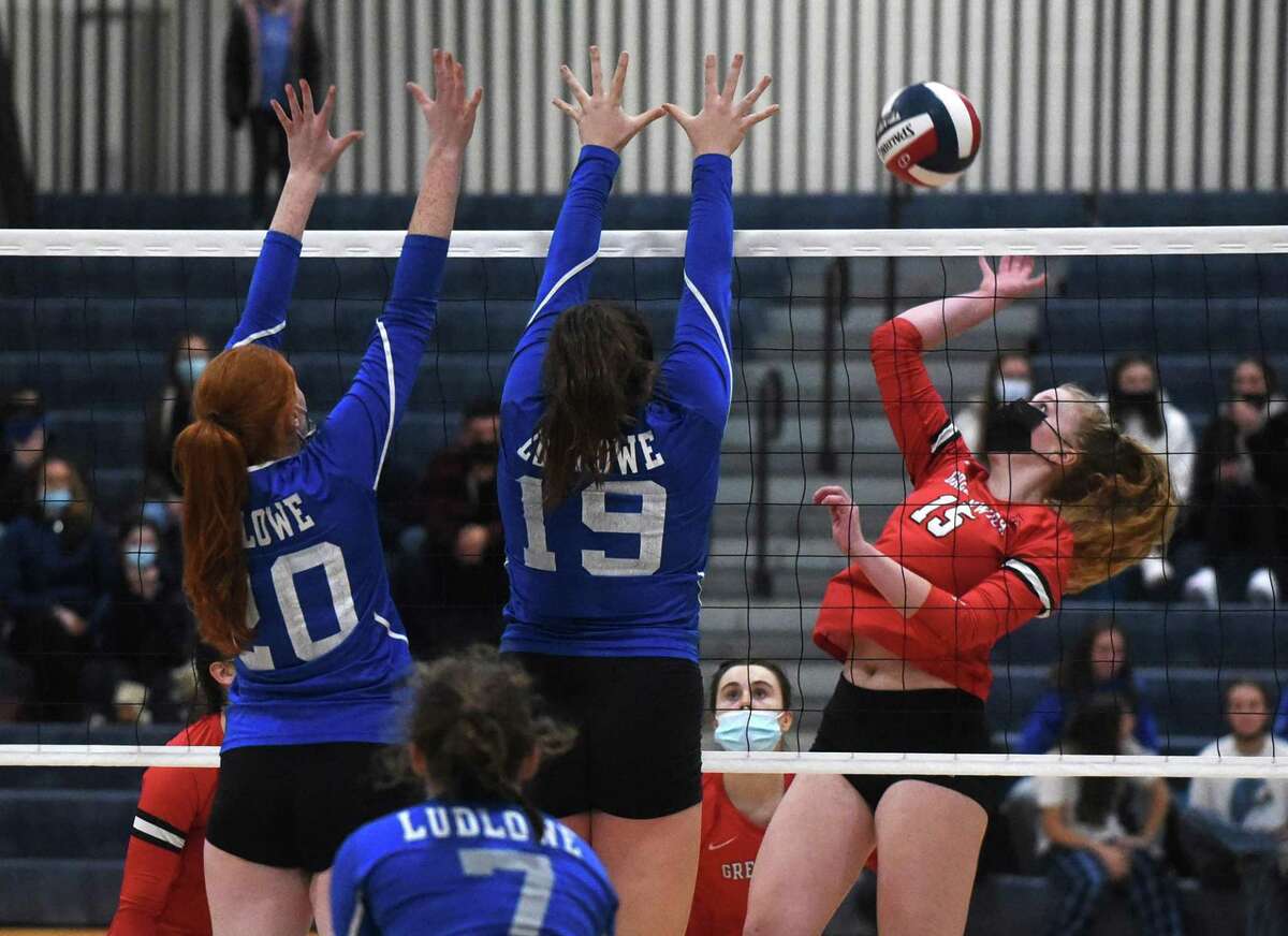 Greenwich's Maggie Saleeby (15) takes a shot while Ludlowe's Caitlin Finnegan (20) and Madison Roman (19) defend during the CIAC Class LL volleyball final in East Haven on Saturday, Nov. 20, 2021.