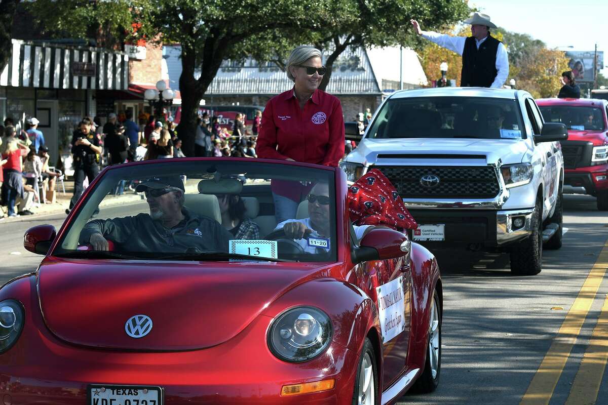 Tomball Mayor Gretchen Fagan rides as a dignitary during the 56th Annual Tomball Holiday Parade which featured about 150 entries marching, performing and driving down Main Street on Saturday, Nov. 20, 2021.