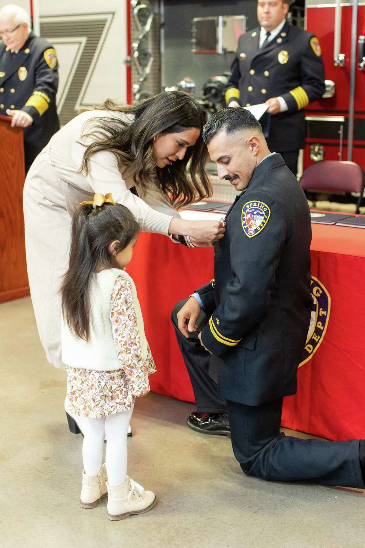 Captain Michael Alaniz is pinned by his wife, Wendy, and daughter, Mila Rose, during the Spring Fire Department's pinning ceremony for officers and apparatus operators who received promotions during the pandemic held Nov. 19, 2021, at Station 71.
