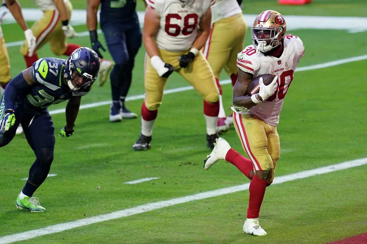 San Francisco 49ers running back Jeff Wilson (30) runs for a touchdown against the Seattle Seahawks during the second half of an NFL football game, Sunday, Jan. 3, 2021, in Glendale, Ariz. (AP Photo/Ross D. Franklin)