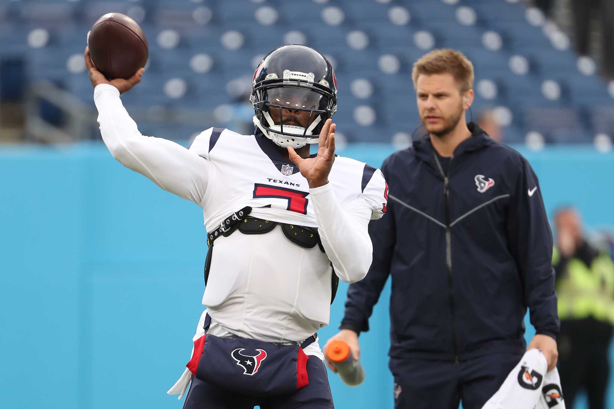 Houston Texans quarterback Tyrod Taylor, top, leaps over Tennessee Titans  safety Amani Hooker ( …