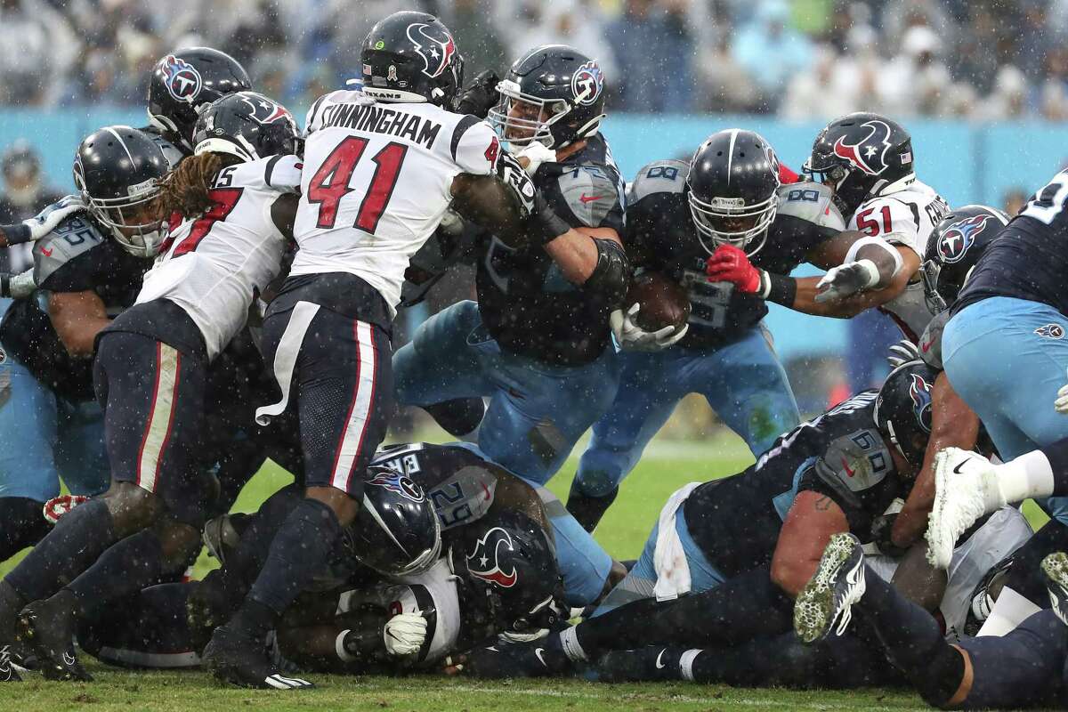 Tennessee Titans running back Adrian Peterson (8) is stopped short of the first down by Houston Texans linebacker Kamu Grugier-Hill (51) during the first half of an NFL football game Sunday, Nov. 21, 2021, in Nashville.