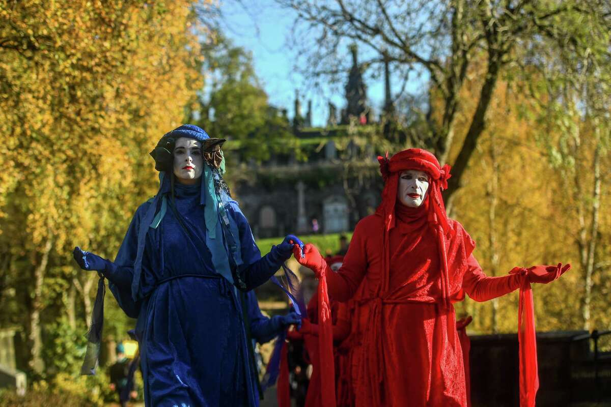 Extinction Rebellion activists are seen holding a Funeral for COP26 at the Necropolis on Nov.13, in Glasgow, United Kingdom. As delegates inside the conference enter final negotiations at COP26, many climate action groups have taken to the streets to protest for real progress to be made by governments to reduce carbon emissions, clean up the oceans, reduce fossil fuel use and other issues relating to global heating.
