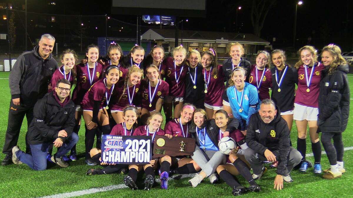 Members of the St. Joseph girls soccer team celebrate their CIAC Class L championship after defeating Simsbury 2-0 Sunday at Dillon Stadium.