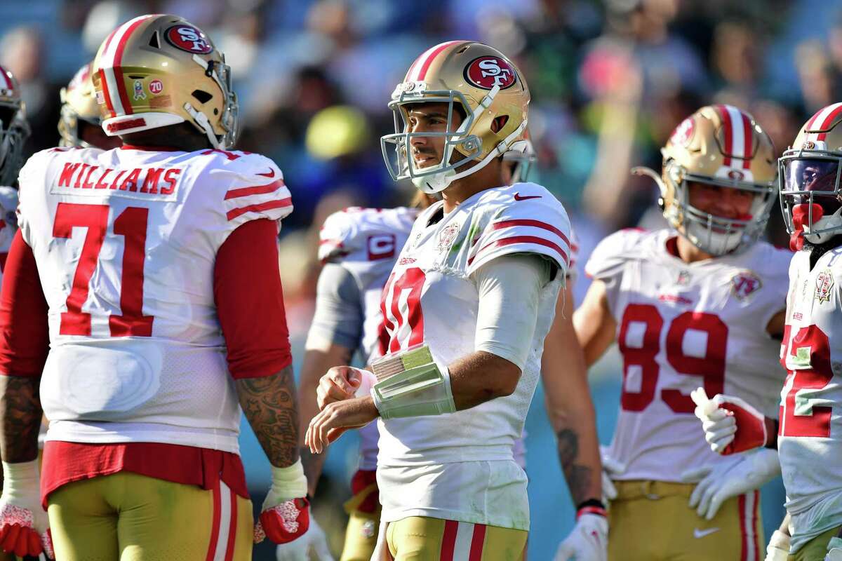 JACKSONVILLE, FLORIDA - NOVEMBER 21: Jimmy Garoppolo #10 of the San Francisco 49ers talks with Trent Williams #71 before a play during the second half against the Jacksonville Jaguars at TIAA Bank Field on November 21, 2021 in Jacksonville, Florida. (Photo by Julio Aguilar/Getty Images)