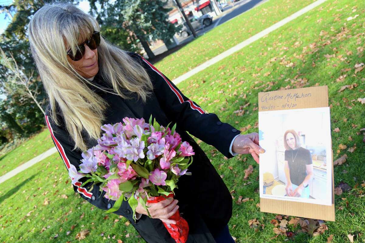 Marilyn Jamgochian, of Milford, holds a picture in tribute of her longtime friend Fairfield resident Christine McMahon, who was killed by a motor vehicle while walking on Mill Plain Road by I-95 last year.