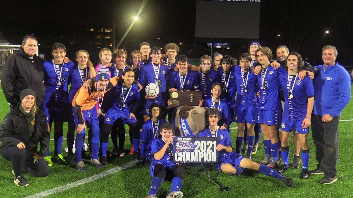 Members of the Old Saybrook boys soccer team celebrate after winning the Class S championship on Sunday night at Dillon Stadium.
