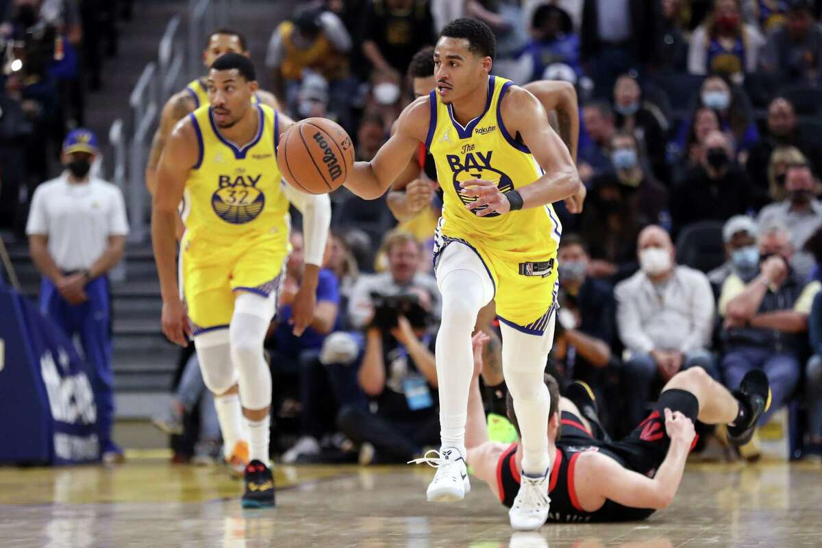 Golden State Warriors' Jordan Poole dribbles up court against Toronto Raptors during NBA game at Chase Center in San Francisco, Calif., on Sunday, November 21, 2021.