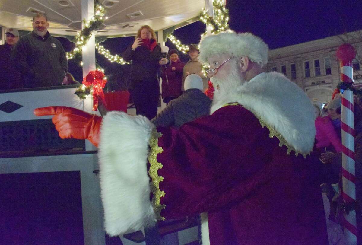 Spectrum/The Greater New Milford Chamber of Commerce held the annual lighting of the trees on the Village Green Nov. 30, 2019. Santa Claus made an appearance and visited with attendees after the trees were lighted. This is the 53rd year the trees have been put up by the Men’s Club of the New Milford United Methodist Church and lighted. Above, Santa acknowledges a believer in the crowd of those gathered for the lighting of the trees.