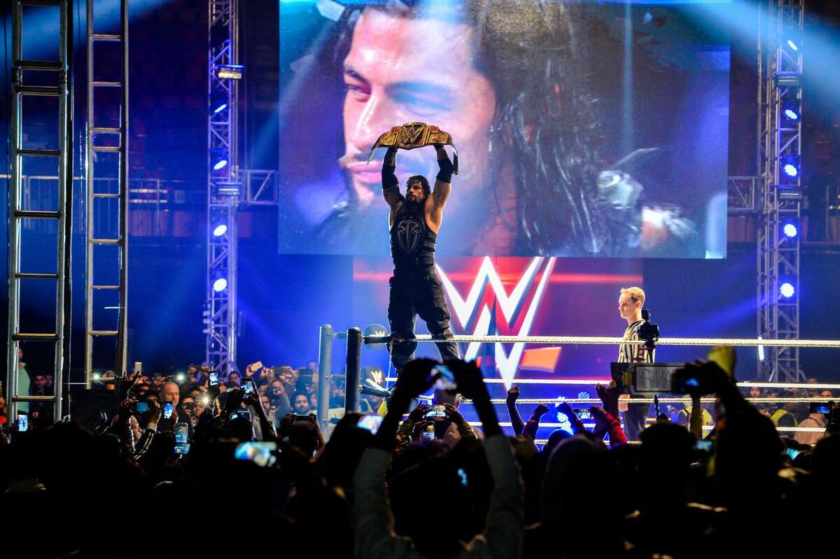 In this photograph taken on January 15, 2016, wrestler Roman Reigns holds up the Championship Belt during the World Wrestling Entertainment (WWE) Live India Tour in New Delhi. 
