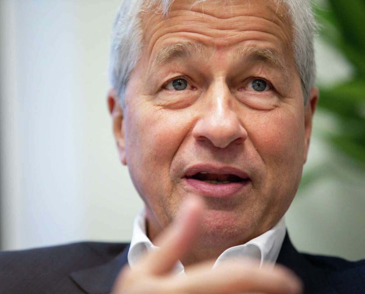 Jamie Dimon, CEO of JPMorgan Chase, talks with a reporter Wednesday, Oct. 27, 2021, at a bank branch in Houston.