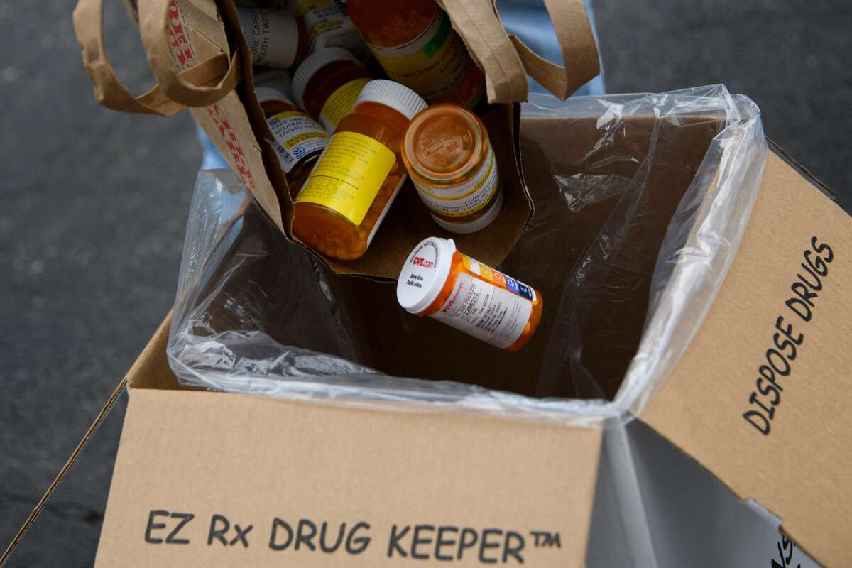 A bag of assorted pills and prescription drugs is poured into a disposal box during a National Prescription Drug Take Back Day in Los Angeles.