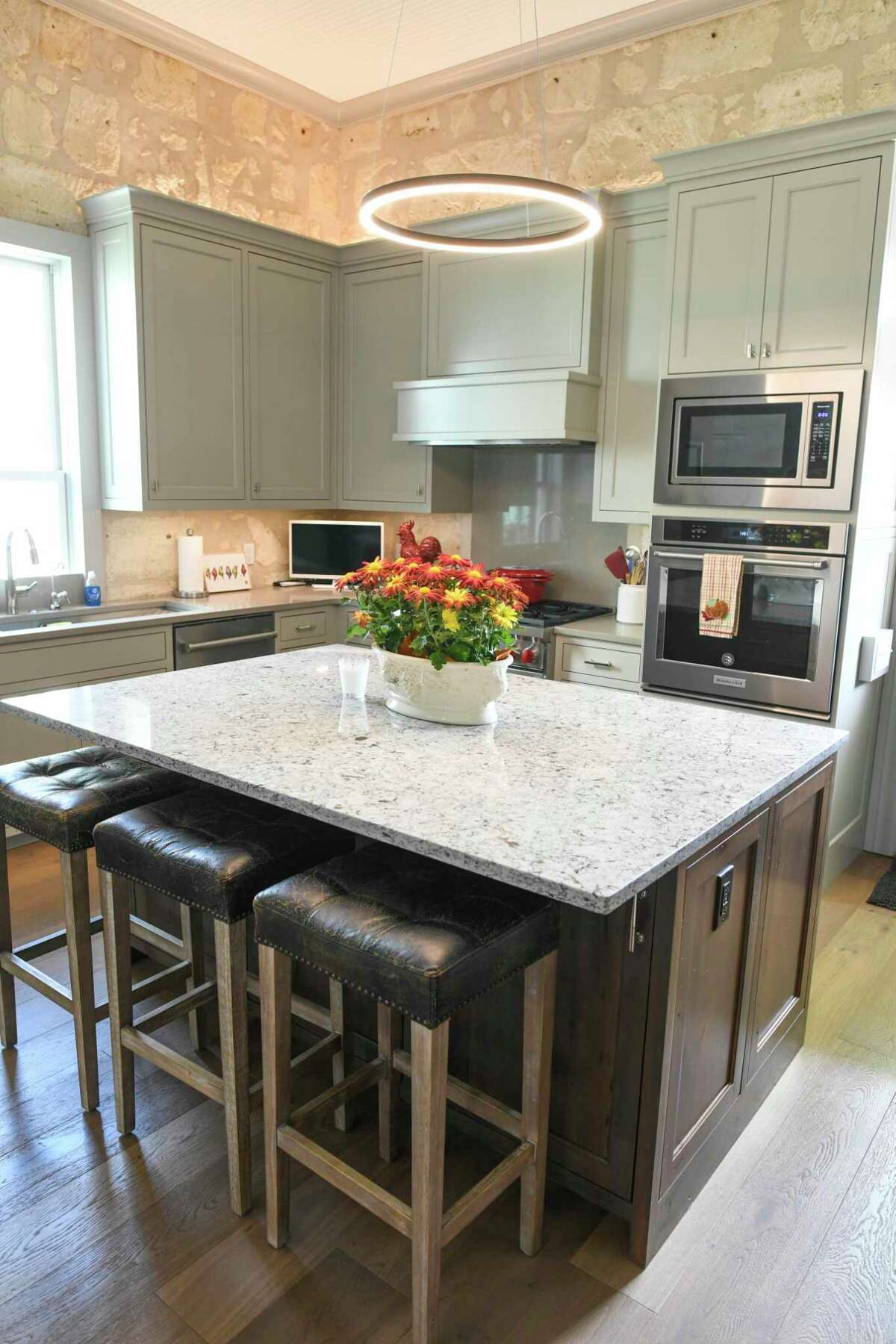 The kitchen in this remodeled Fredericksburg home includes a modern island with an overhang to make seating easier.