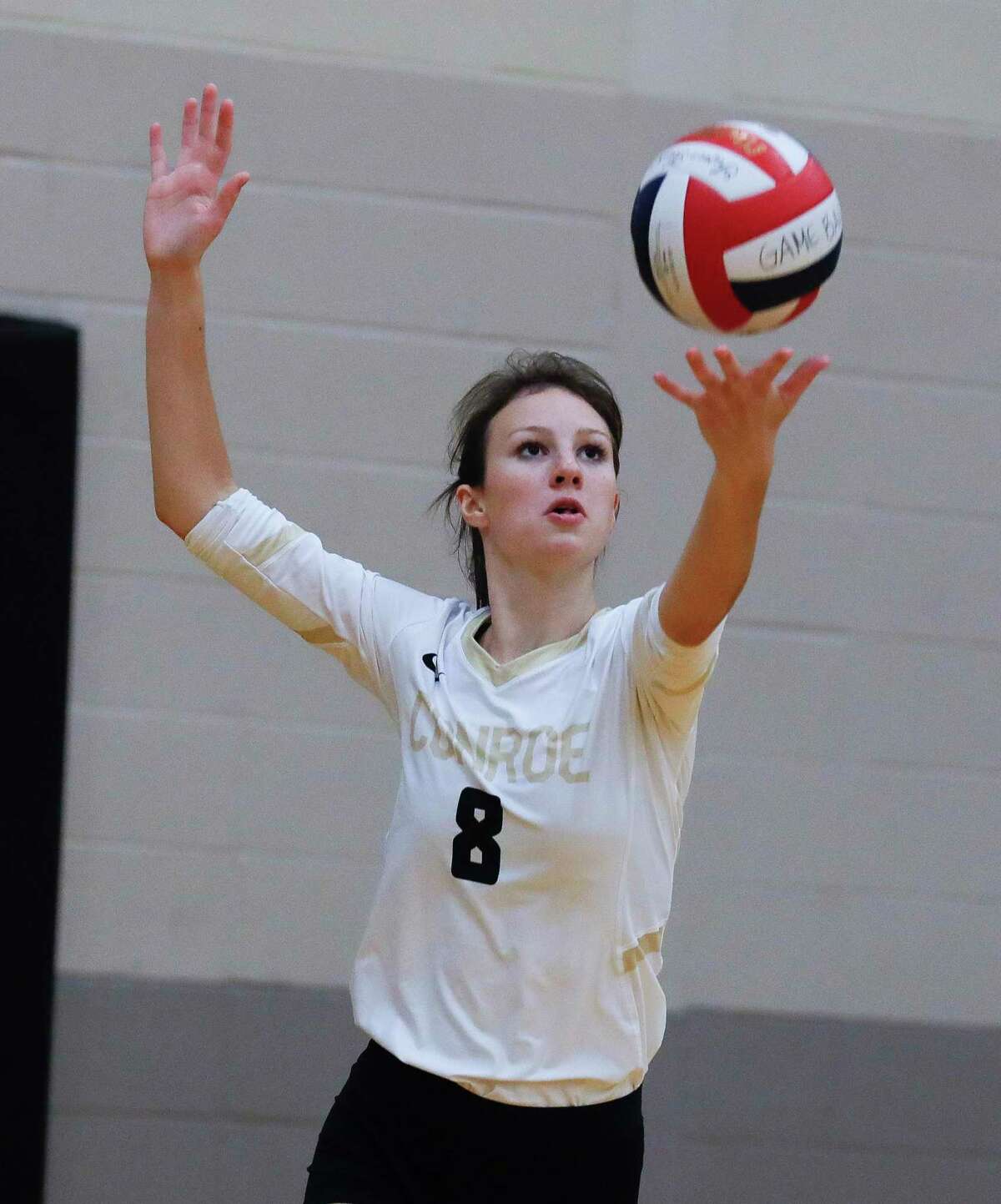 Conroe middle blocker Brooklyn Spikes (8) serves the ball during the third set of a non-district high school volleyball match at Conroe High School, Wednesday, Sept. 15, 2021, in Conroe.