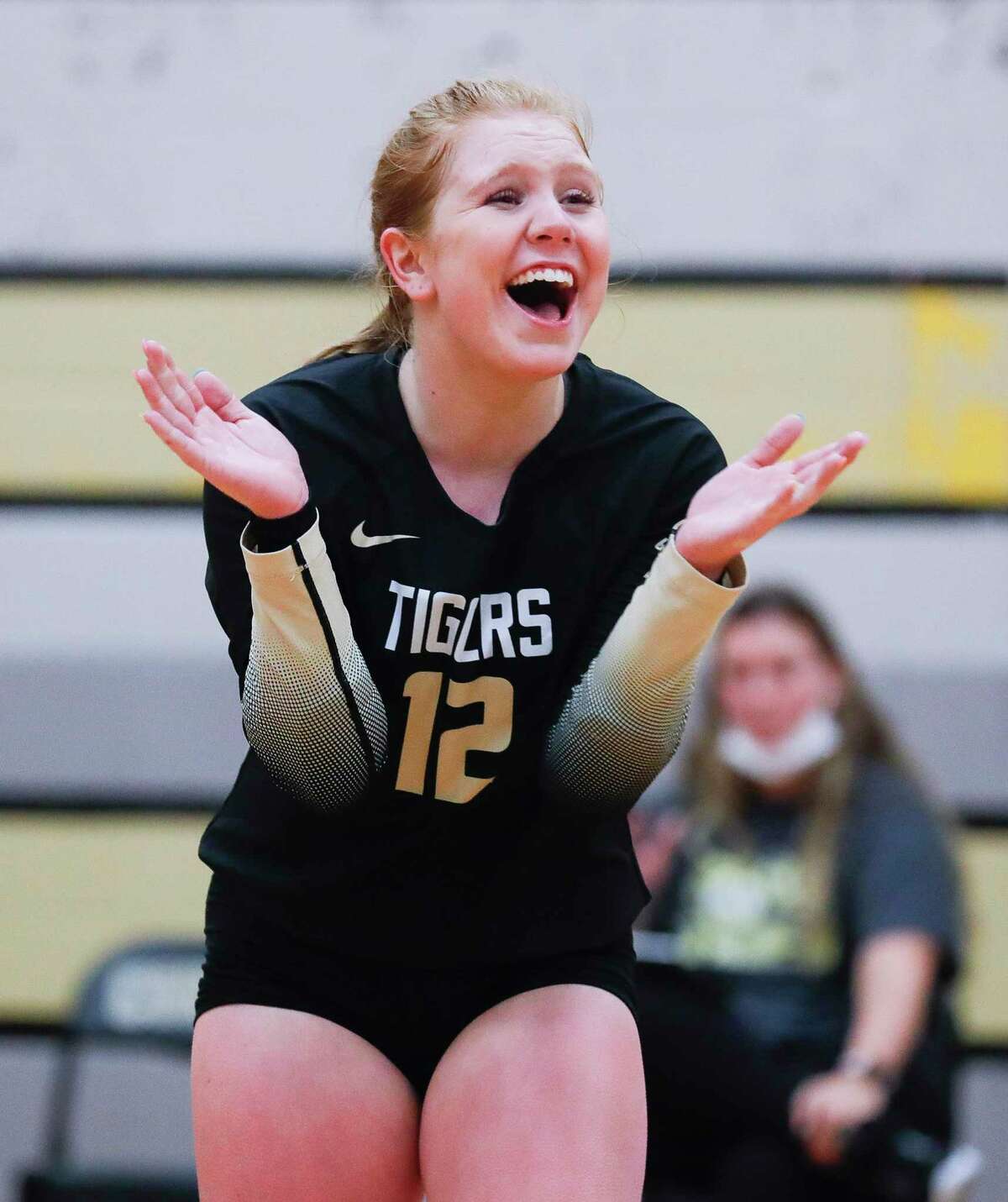 Conroe libero Emma Malak (12) cheers during the third set of a non-district high school volleyball match at Conroe High School, Wednesday, Sept. 15, 2021, in Conroe.