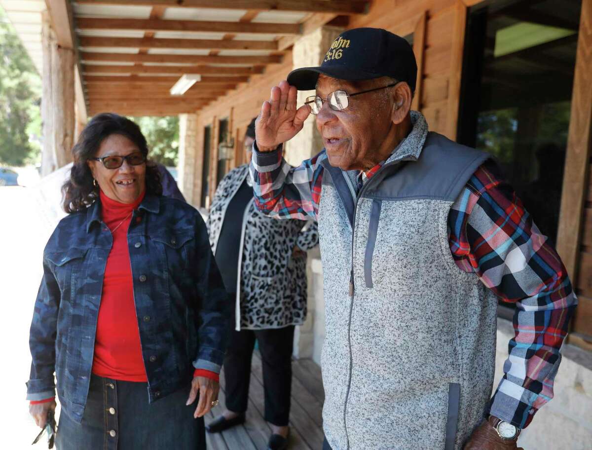 Tamina resident and U.S. Army veteran Romie Hollins, 90, salutes those volunteers and community members who have come together to help refurbish his home, Friday, Nov. 19, 2021, in Conroe. Hollins and his wife, Eva, received a $10,000 check from Texas Professional Surveying & Engineering to help cover some of the expenses with updating his home.