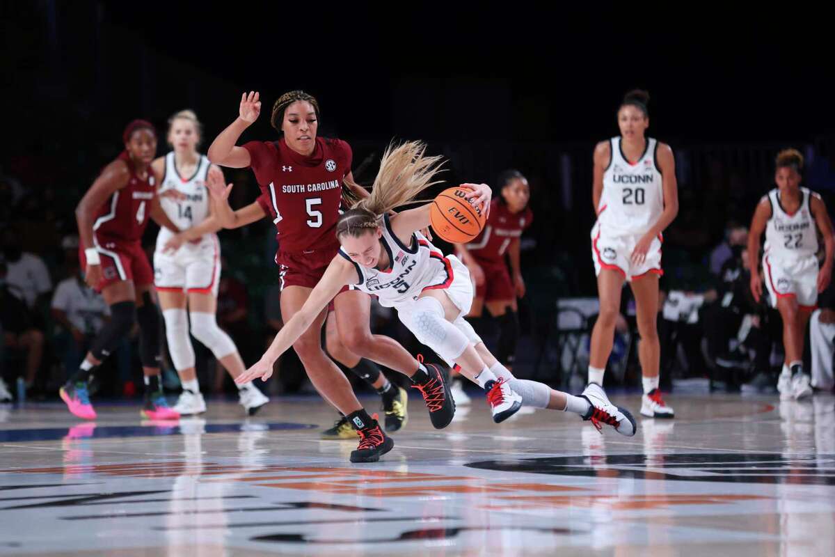 In this photo provided by Bahamas Visual Services, South Carolina forward Victaria Saxton (5) defends against UConn guard Paige Bueckers (5) during an NCAA college basketball game at Paradise Island, Bahamas, Monday, Nov. 22, 2021.