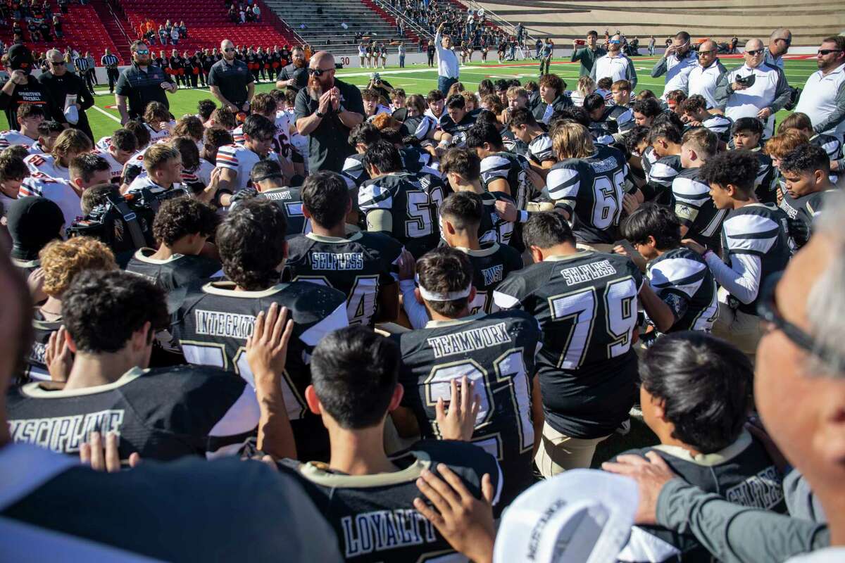 First Baptist Andrews youth pastor Ricky Galvan leads Andrews and Springtown players in prayer before the game Monday, Nov. 22, 2021 at Mustang Bowl in Sweetwater. Jacy Lewis/Reporter-Telegram