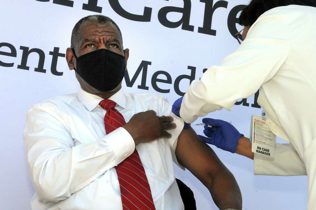Rev. Carl McCluster of Shiloh Baptist Church receives a COVID-19 vaccination during a news conference in front of St. Vincent’s Medical Center, in Bridgeport, Conn. Feb. 26, 2021.