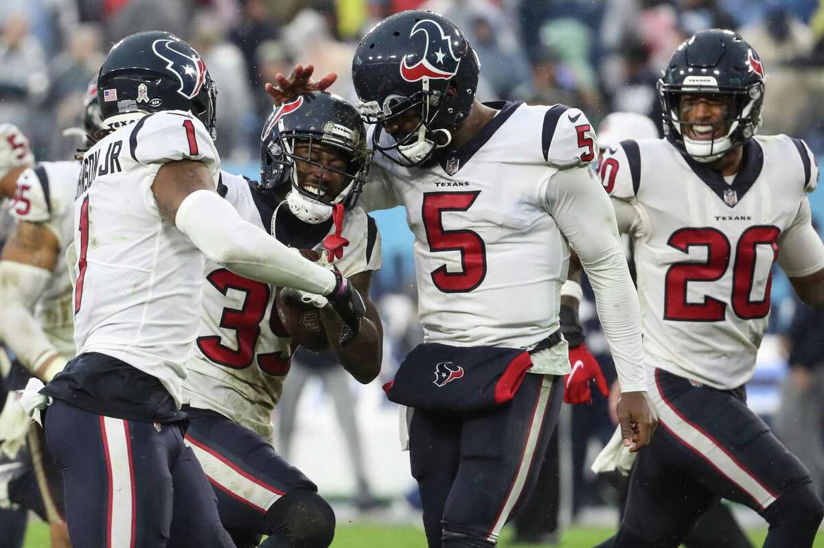 Texans cornerback Terrance Mitchell (39) celebrates with Tyrod Taylor (5) and Lonnie Johnson Jr. (1) after intercepting a pass in the second half against Tennessee to help secure a victory.