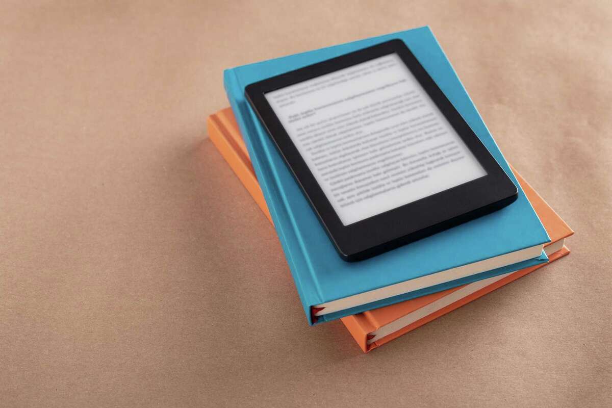 E-book reader, stack of books