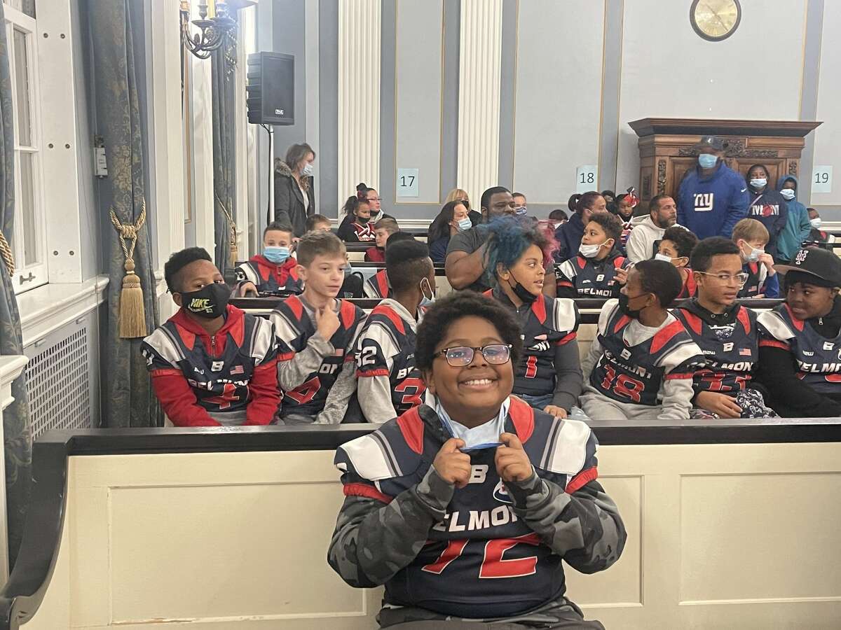 This Schenectady-Belmont Pop Warner football player is all smiles he waits for a citation honoring the team from Schenectady's City Council on Monday, Nov. 22, 2021.