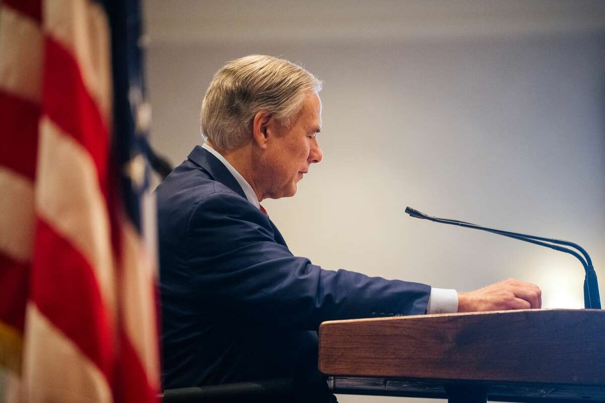 Governor Greg Abbott glances at his notes while delivering a speech at the Houston Region Business Coalition's monthly meeting on October 27, 2021 in Houston, Texas.