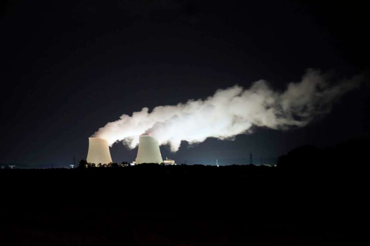 FILE - Steam escapes at night from the nuclear plant of Nogent-sur-Seine, 110 kms (63 miles) south east of Paris, Sunday, Aug. 8, 2021. Nuclear power is a central sticking point as negotiators plot out the world’s future energy strategy at the Glasgow climate talks. Critics decry its mammoth price tag, the accident risk and deadly waste. But a growing pro-nuclear camp argues that it’s safer on average than nearly any other energy source. (AP Photo/Francois Mori, File)