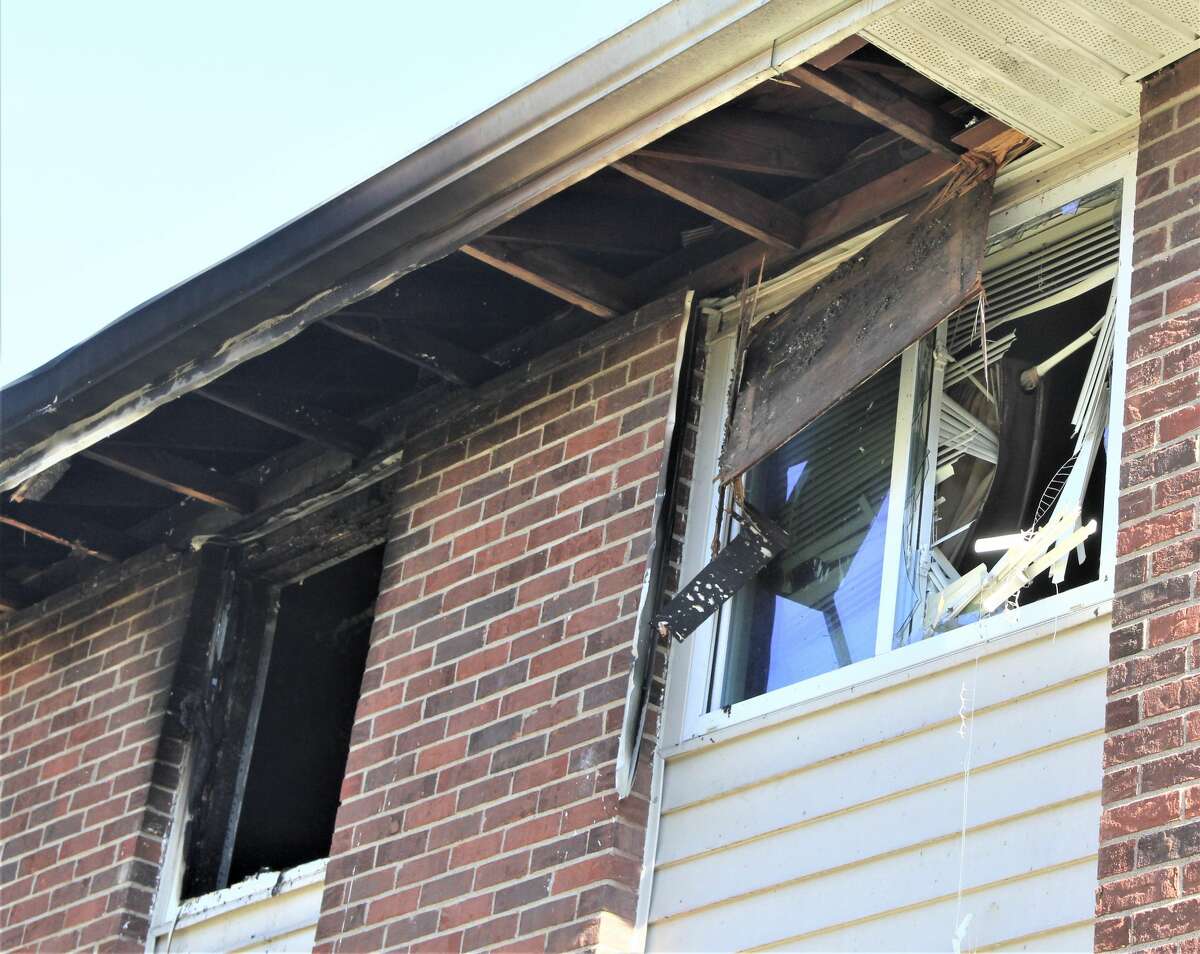 A fire-scarred building is seen at the Landing at Belle Meadows Apartment Complex in the 300 block of Mitchell Street in Alton. A young Alton child was killed in the Monday night blaze.  