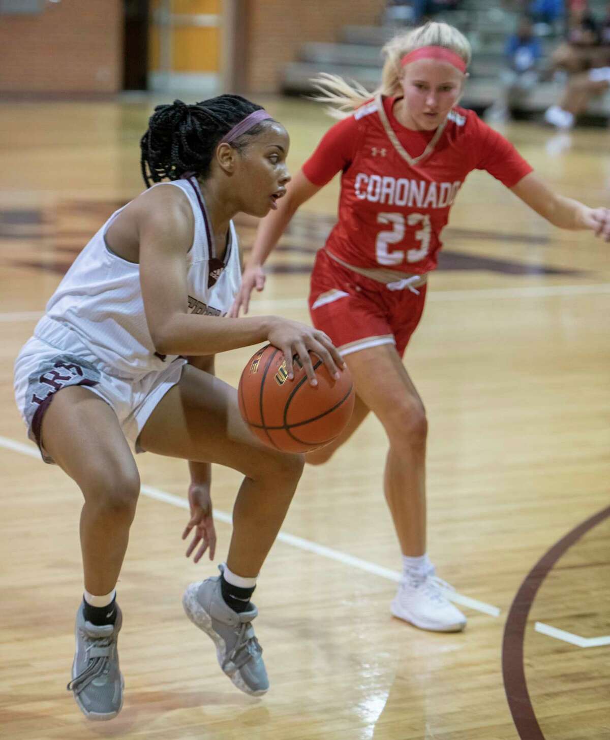 Legacy high's Myleah Young brings the ball down court as Coronado's Trista Arnold defends 11/23/2021 at Legacy High gym. Tim Fischer/Reporter-Telegram