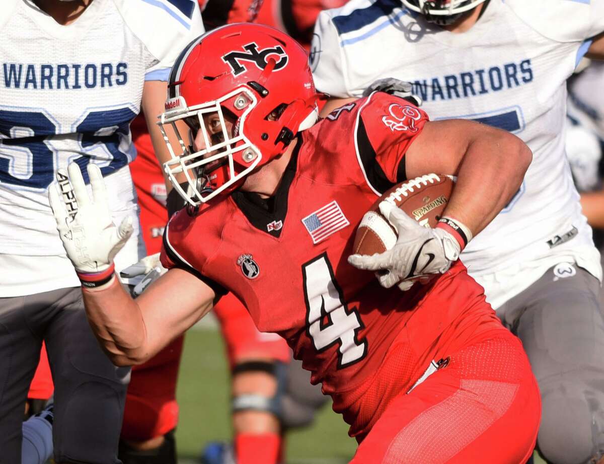 New Canaan’s Vin Cognetta (4) carries against Wilton on Oct. 23.