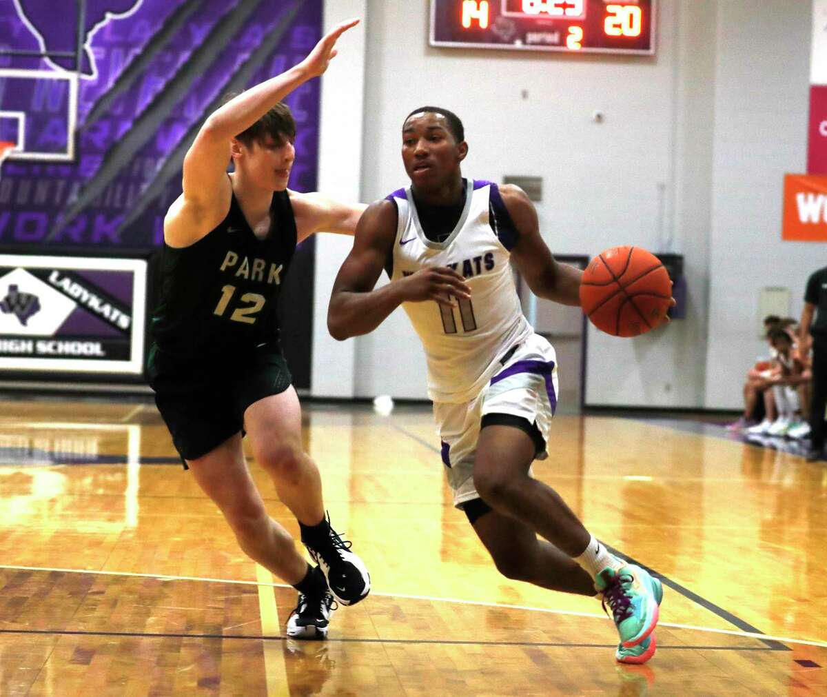 Willis guard Terrance Patterson (0) drives past Kingwood Park power forward Kyle Connelly (12) during the first quarter of a high school basketball game at Willis High School, Tuesday, Nov. 23, 2021, in Willis.