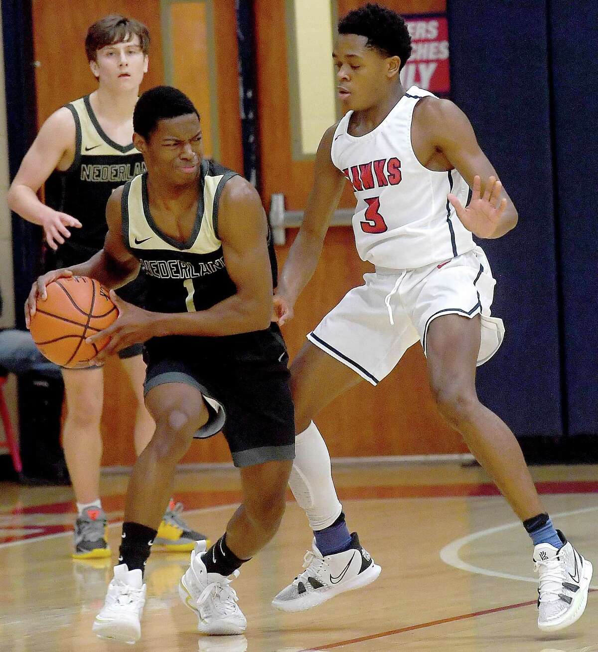 Hardin - Jefferson's Isaiah Melvo presses as Nederland's Derrick Rhodes tries to move the ball into the paint during Tuesday's game in Sour Lake. Photo made Tuesday, November 23, 2021 Kim Brent/The Enterprise