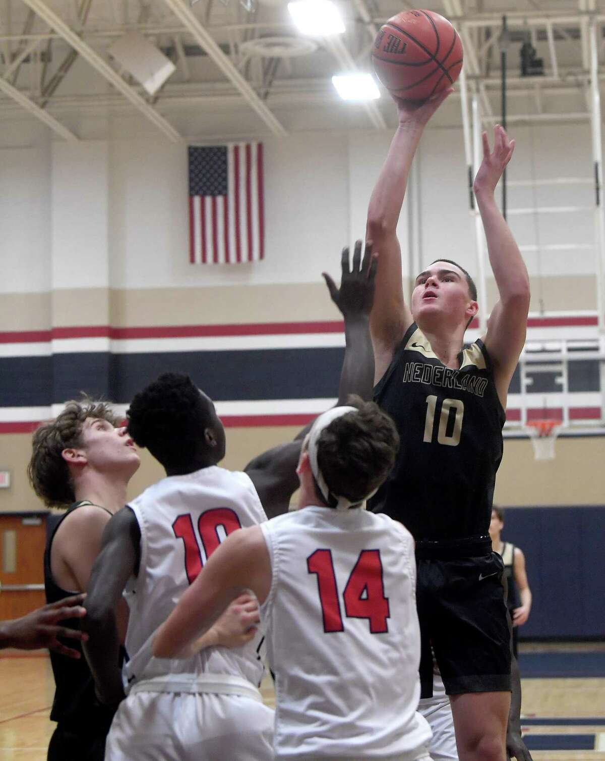 Hardin - Jefferson's defense moves in as Nederland's Tripp Parker shoots during Tuesday's game in Sour Lake. Photo made Tuesday, November 23, 2021 Kim Brent/The Enterprise