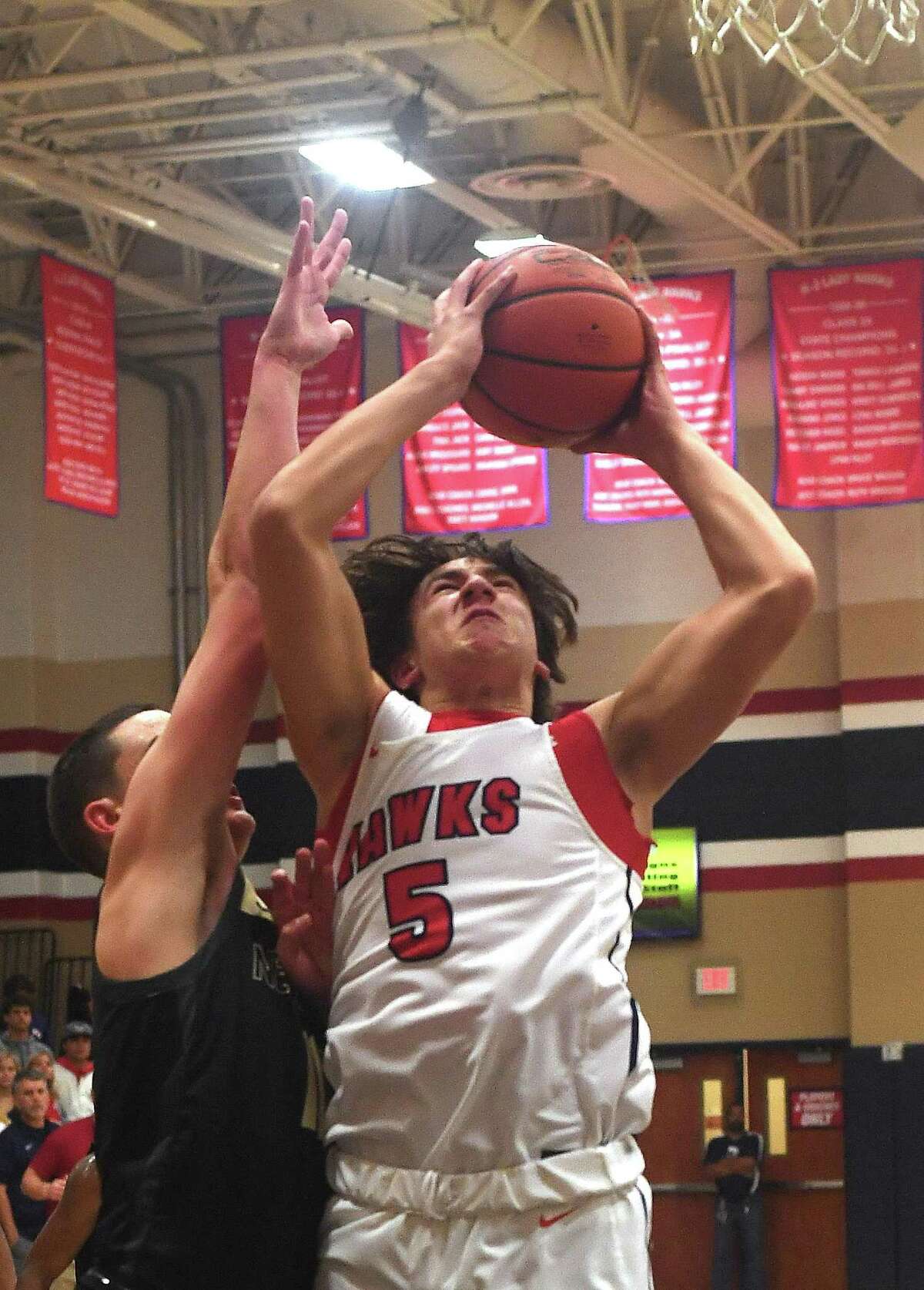 Hardin - Jefferson's Wyatt Samaha puts up his shot against Nederland's Derrick Rhodes during Tuesday's game in Sour Lake. Photo made Tuesday, November 23, 2021 Kim Brent/The Enterprise