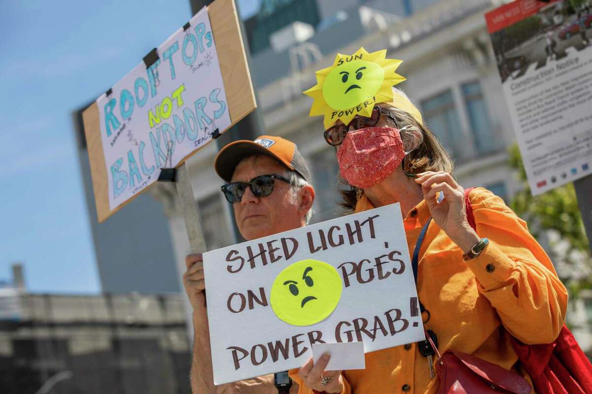 Michael and Nancy Olexo protest outside the California Public Utilities Commission’s San Francisco offices in June.