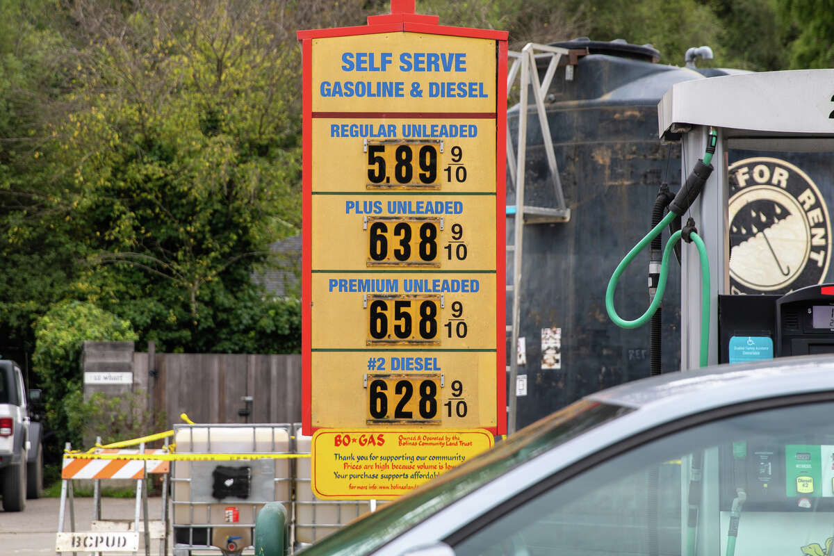 FILE - Gas prices in California are the highest in the country. Pictured is a board outside a gas station in Bolinas, Calif., on Nov. 18, 2021.