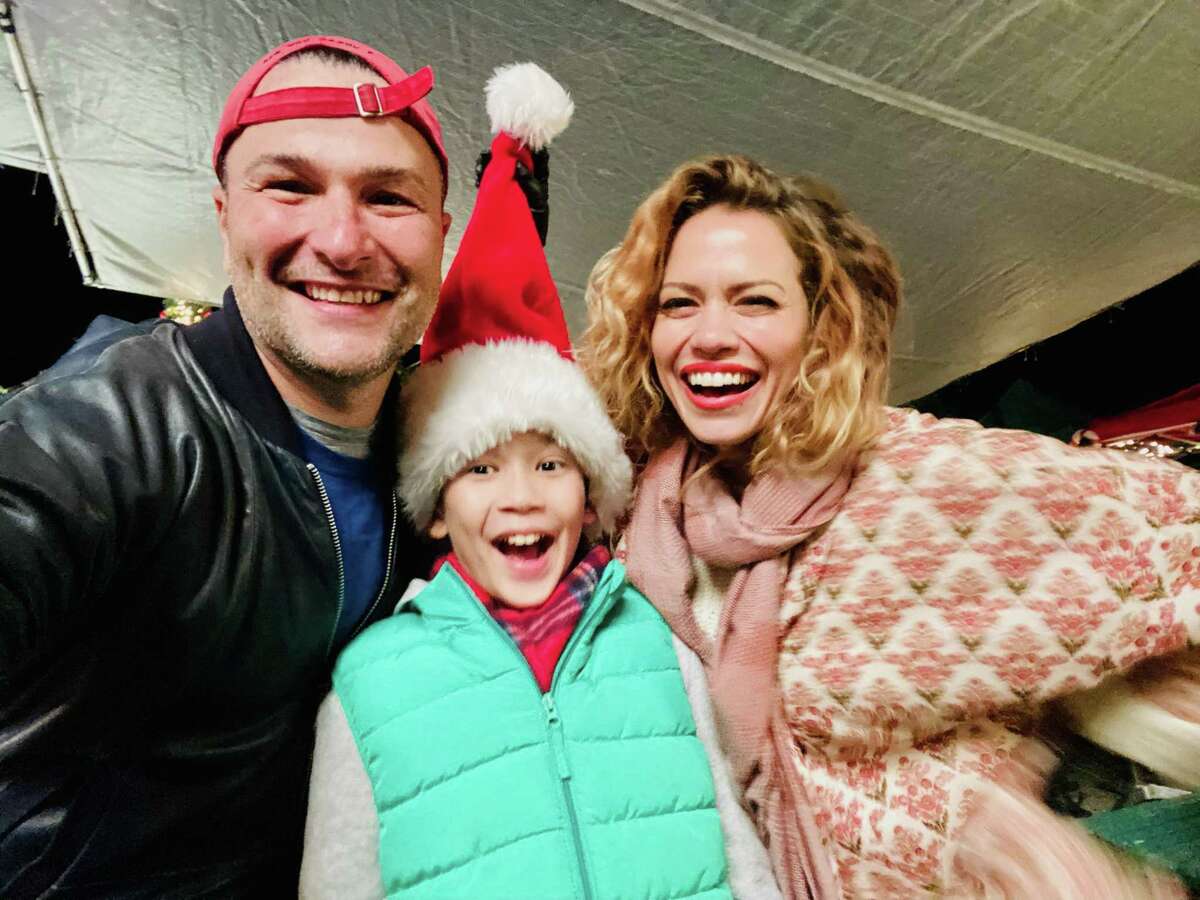 On the set of Hallmark’s movie “An Unexpected Christmas” is from left to right, executive producer Matthew Brady, Logan McInnes who plays Scotty and Bethany Joy Lenz, the star of the movie, who plays Emily.