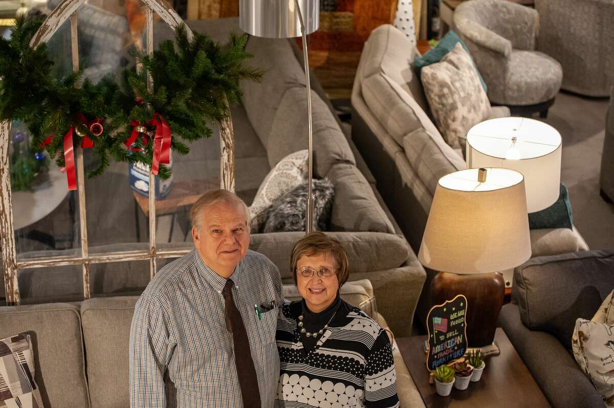 Lee and Kathy Kilbourn pose inside the Tri City Furniture store on Nov. 23, 2021 at 135 W. Midland Road in Auburn. The Kilbourns are the store owners.