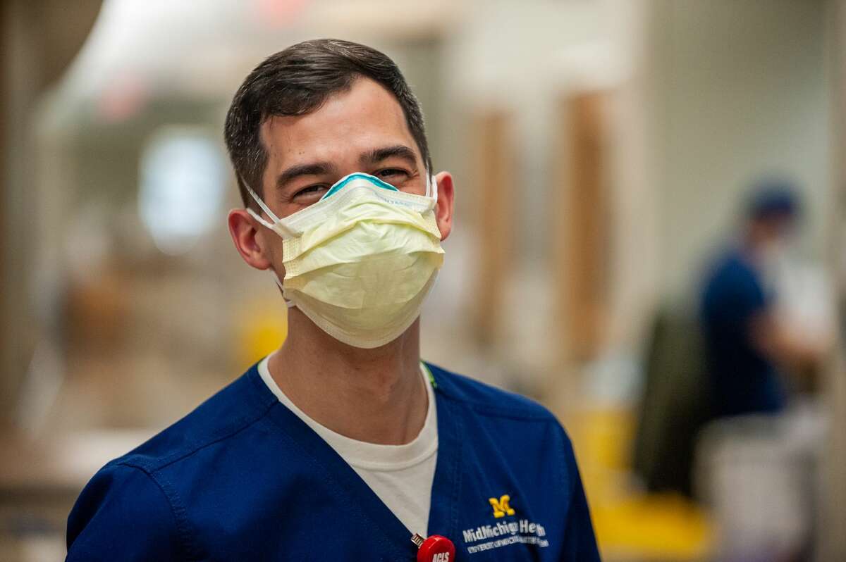 Mid-Michigan registered nurse Kyle Gordon-Bidwell poses inside a Medical Intensive Care Unit wing on Nov. 23, 2021.