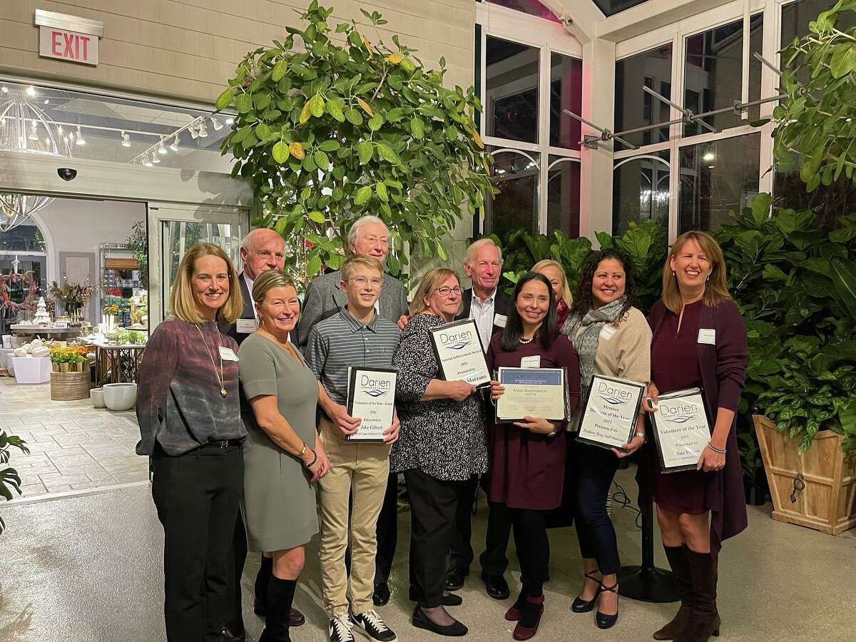 Eight year member of the Darien Community Association Board of Directors, Sue Hayes, and the Darien Men’s Association have won the 2021 Darien Chamber of Commerce Volunteer Awards from the Darien Chamber of Commerce. A photo from the event is shown.