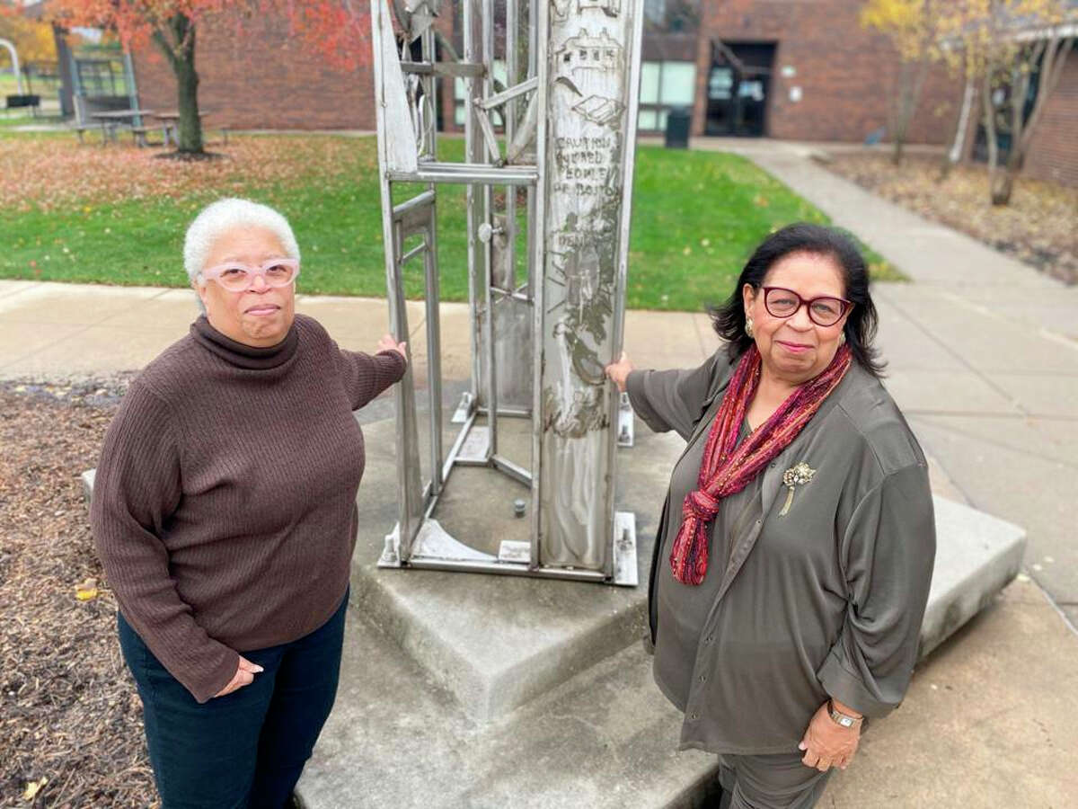 Angela Rivers and Barbara Suggs Mason at the Frederick Douglass: In Remembrance sculpture at the Douglass Branch Library in Champaign.