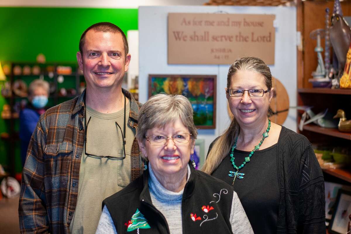 From left to right: Andy Widmer, Sherry Klapish and Angie Klapish-Widmer pose inside the Great Gifts, Arts, Antiques, and Handmades store in Midland on Nov. 24, 2021. Andy Widmer and Angie Klapish-Widmer are the co-owners of the store and Sherry Klapish is the store manager.