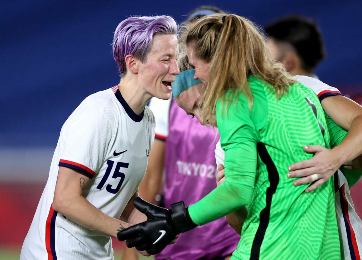 Megan Rapinoe #15 and Alyssa Naeher #1 of Team United States celebrate following their team's victory in the penalty shoot out after the Women's Quarter Final match between Netherlands and United States on day seven of the Tokyo 2020 Olympic Games at International Stadium Yokohama on July 30, 2021 in Yokohama, Kanagawa, Japan. 