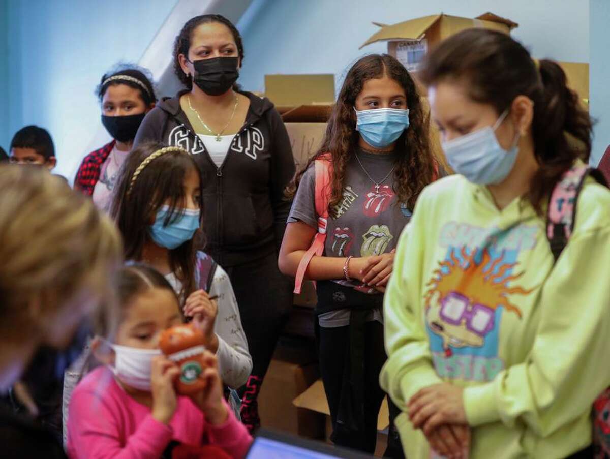 10-year-old Heidy Martinez (center) waits with other kids to get their COVID-19 vaccines in Richmond.